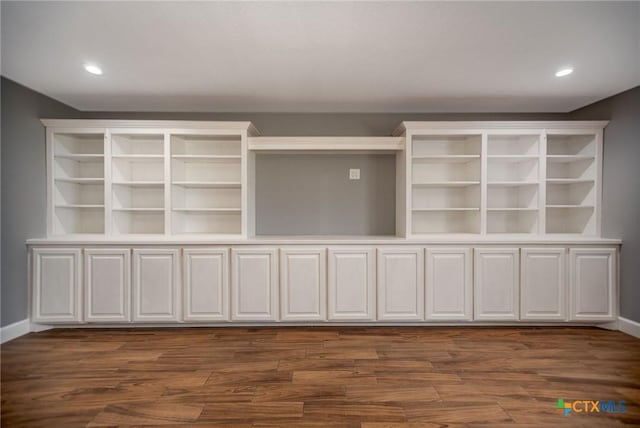 248 Park Rd, Port Lavaca, TX 77979 - unfurnished living room with dark wood-type flooring, baseboards, and recessed lighting
