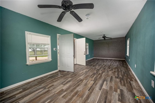 248 Park Rd, Port Lavaca, TX 77979 - empty room featuring ceiling fan, wood finished floors, baseboards, an accent wall, and vaulted ceiling