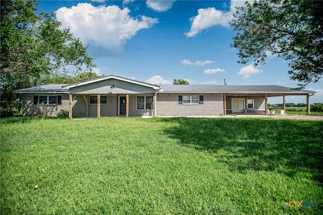 248 Park Rd, Port Lavaca, TX 77979 - view of front facade featuring an attached carport, a front lawn, and brick siding