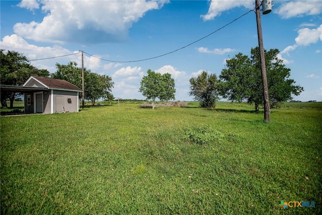 248 Park Rd, Port Lavaca, TX 77979 - view of green lawn with an outbuilding, a storage shed, and a view of countryside