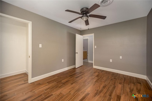 248 Park Rd, Port Lavaca, TX 77979 - unfurnished bedroom featuring baseboards, wood finished floors, and a ceiling fan
