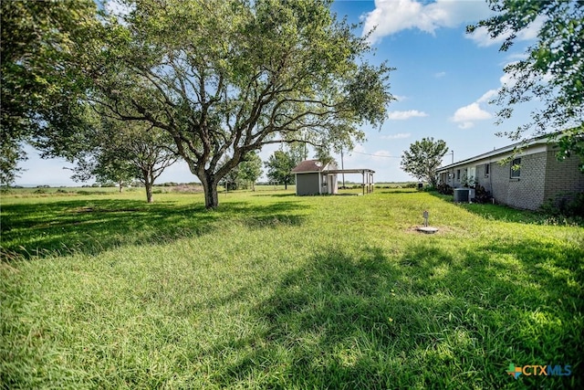 248 Park Rd, Port Lavaca, TX 77979 - view of green lawn featuring central AC unit, an outdoor structure, and a shed