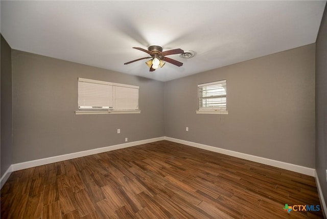 248 Park Rd, Port Lavaca, TX 77979 - empty room with baseboards, ceiling fan, and dark wood finished floors