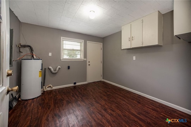 248 Park Rd, Port Lavaca, TX 77979 - laundry room featuring cabinet space, water heater, wood finished floors, electric dryer hookup, and baseboards
