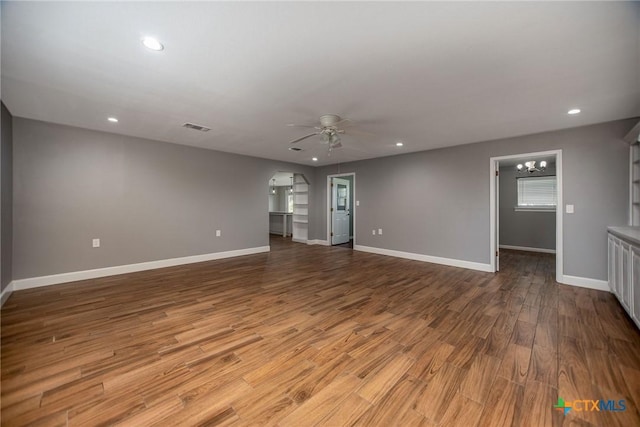 248 Park Rd, Port Lavaca, TX 77979 - spare room with a ceiling fan, a chandelier, baseboards, wood finished floors, and recessed lighting