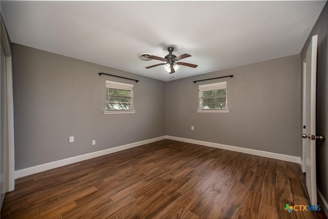 248 Park Rd, Port Lavaca, TX 77979 - spare room featuring plenty of natural light, ceiling fan, baseboards, and dark wood-style floors