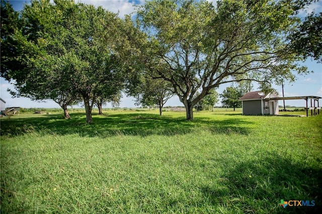 248 Park Rd, Port Lavaca, TX 77979 - view of green lawn featuring a carport