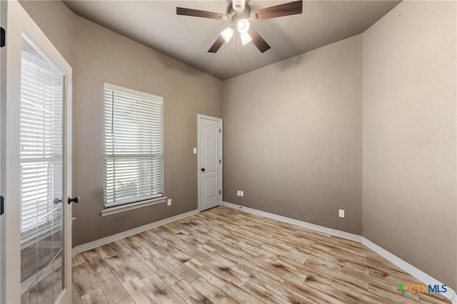 unfurnished room with light wood-style flooring, baseboards, and ceiling fan