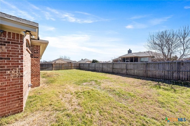 view of yard with a fenced backyard