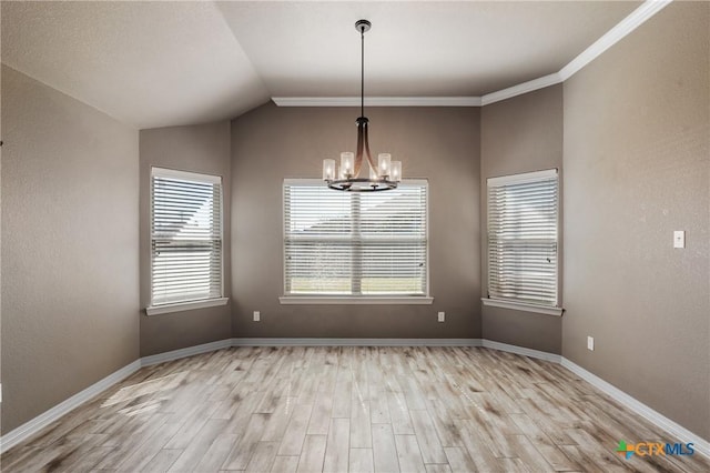 unfurnished room featuring a notable chandelier, lofted ceiling, a textured wall, light wood-style floors, and baseboards