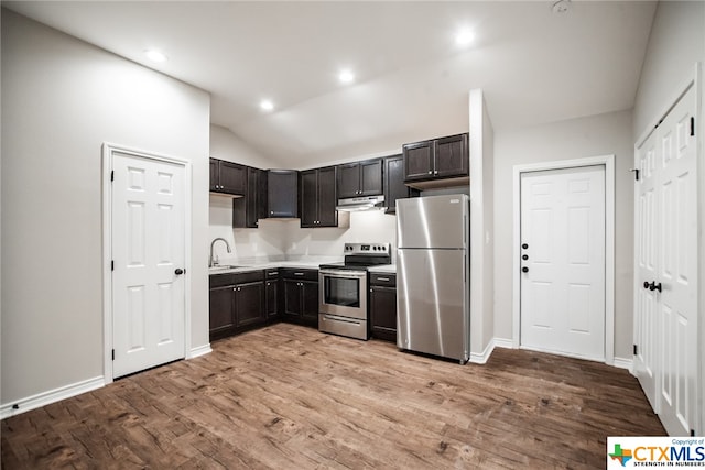 kitchen with light hardwood / wood-style floors, lofted ceiling, sink, dark brown cabinets, and appliances with stainless steel finishes