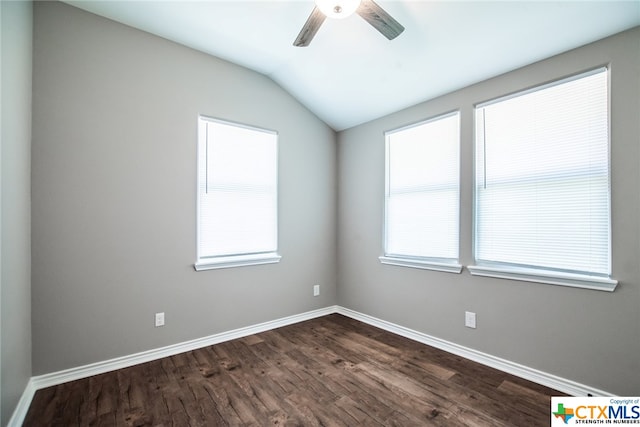 spare room with dark hardwood / wood-style flooring, lofted ceiling, and a healthy amount of sunlight