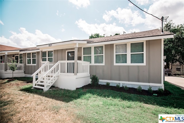 rear view of property with a yard