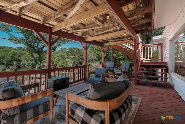 deck featuring stairway and outdoor lounge area