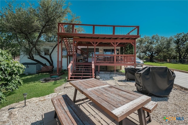 wooden deck with stairs, a lawn, a patio area, and area for grilling