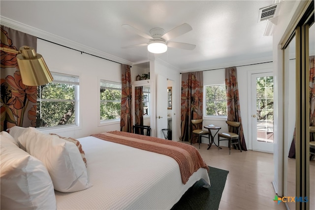 bedroom featuring crown molding, access to exterior, a ceiling fan, wood finished floors, and visible vents