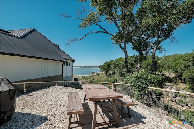 view of patio / terrace featuring a water view and outdoor dining area