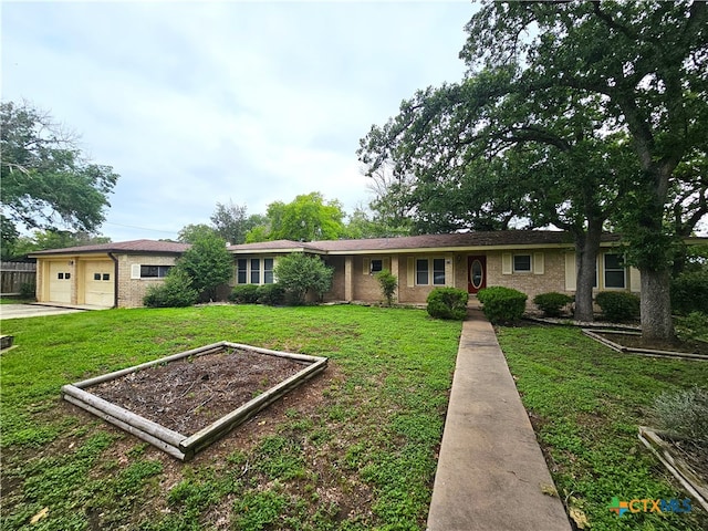 ranch-style home with a front lawn and a garage