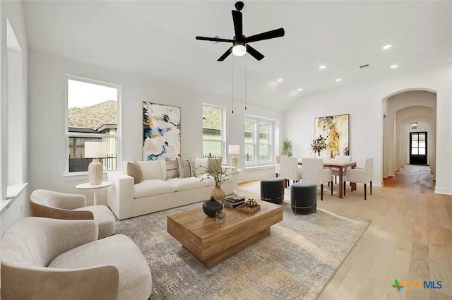 living room with vaulted ceiling, ceiling fan, and light hardwood / wood-style floors