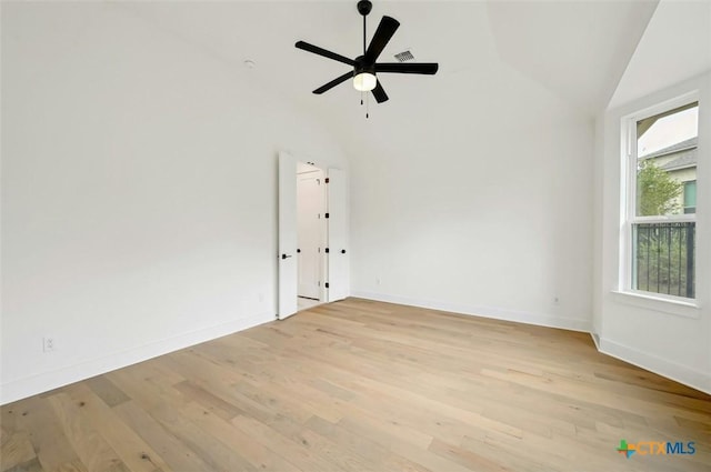 empty room with light hardwood / wood-style flooring, vaulted ceiling, and ceiling fan