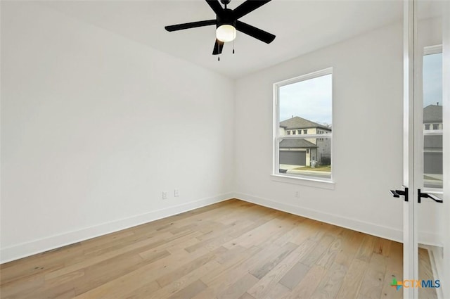 spare room with ceiling fan and light wood-type flooring