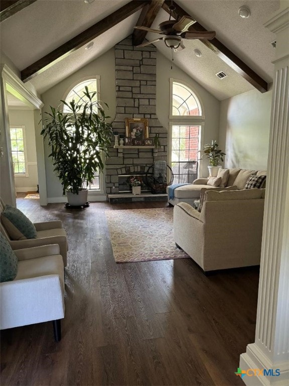 507 Hackberry Bnd, Port Lavaca, TX 77979 - living room featuring a ceiling fan, wood finished floors, a stone fireplace, baseboards, and a textured ceiling