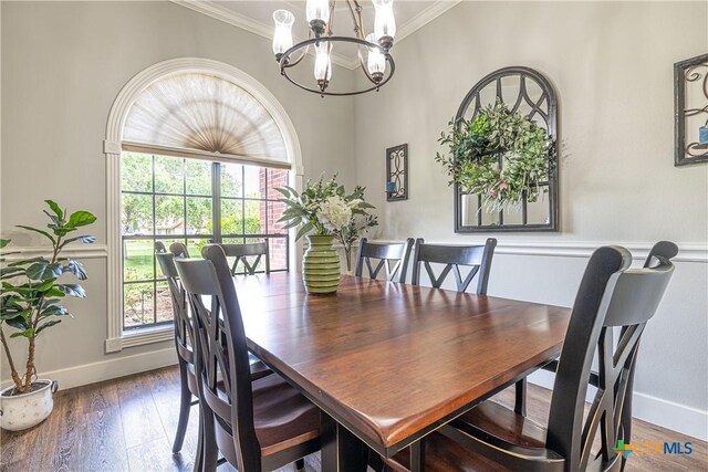 507 Hackberry Bnd, Port Lavaca, TX 77979 - dining space featuring a chandelier, ornamental molding, baseboards, and wood finished floors
