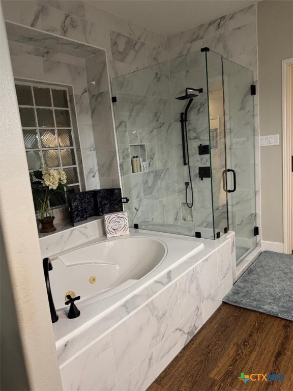 507 Hackberry Bnd, Port Lavaca, TX 77979 - bathroom featuring a marble finish shower, a jetted tub, and wood finished floors