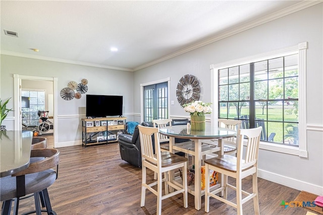 507 Hackberry Bnd, Port Lavaca, TX 77979 - dining area featuring plenty of natural light, dark wood-style flooring, ornamental molding, and baseboards