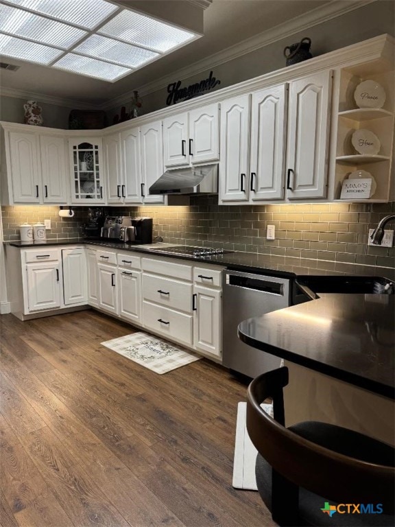 507 Hackberry Bnd, Port Lavaca, TX 77979 - kitchen featuring stainless steel dishwasher, crown molding, under cabinet range hood, white cabinetry, and backsplash