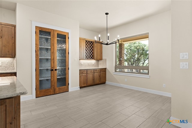 4231 Cold Springs Dr, Copperas Cove, TX 76539 - unfurnished dining area featuring baseboards, french doors, and a chandelier