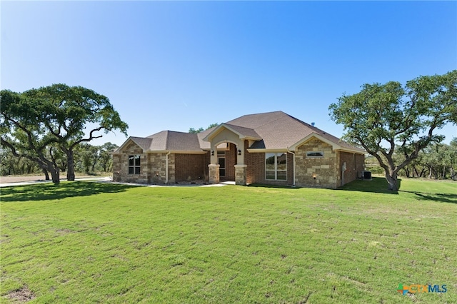 4231 Cold Springs Dr, Copperas Cove, TX 76539 - view of front of home with brick siding, a shingled roof, a front yard, and central AC unit
