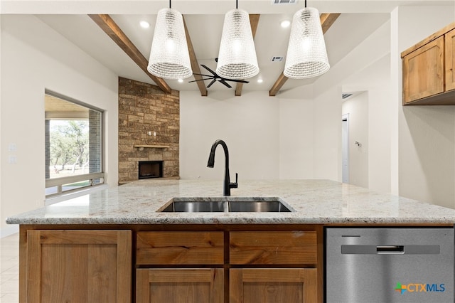 4231 Cold Springs Dr, Copperas Cove, TX 76539 - kitchen featuring stainless steel dishwasher, a stone fireplace, a sink, open floor plan, and beamed ceiling
