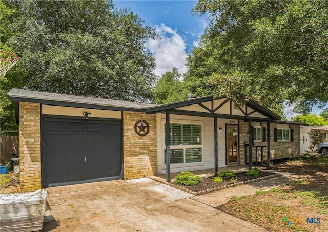 ranch-style home with a garage and covered porch