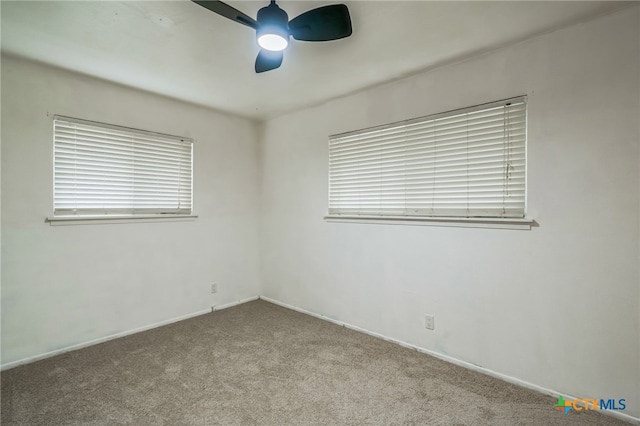 carpeted spare room with ceiling fan