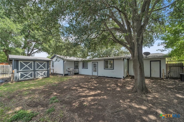 view of front of house featuring a storage unit