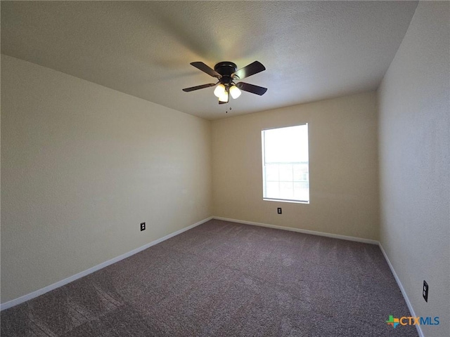 spare room with carpet floors, ceiling fan, baseboards, and a textured ceiling