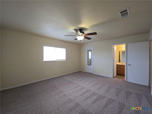 unfurnished bedroom with visible vents, baseboards, ceiling fan, carpet, and a textured ceiling