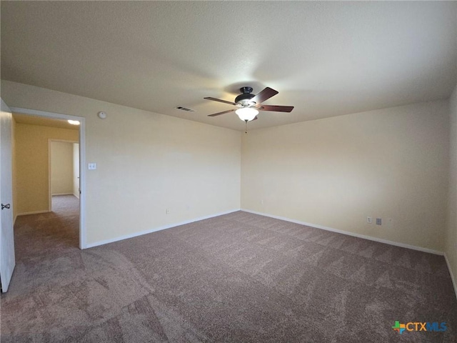 unfurnished room featuring a ceiling fan, carpet flooring, visible vents, and baseboards