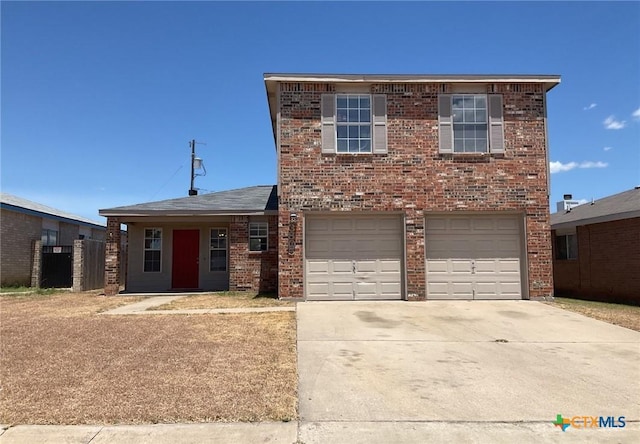 traditional-style home with a garage, concrete driveway, and brick siding