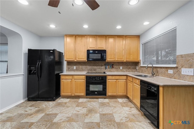 kitchen featuring a sink, tasteful backsplash, a ceiling fan, and black appliances