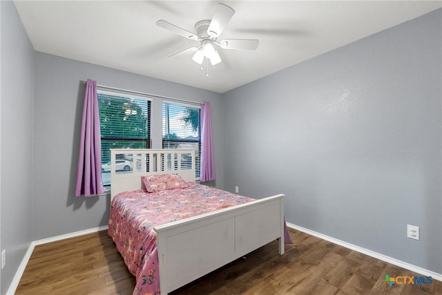 bedroom with baseboards, a ceiling fan, and wood finished floors