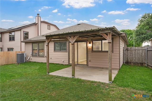 back of house with roof with shingles, a lawn, central air condition unit, a fenced backyard, and a patio