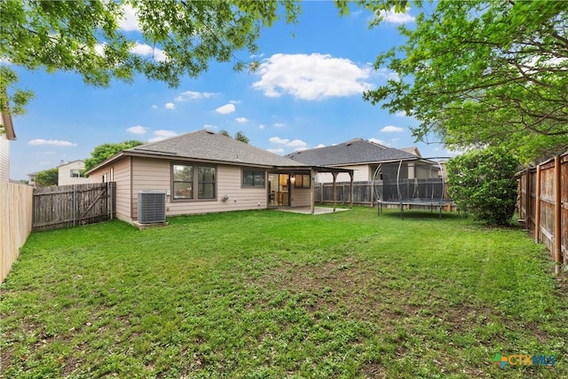 back of property featuring a lawn, central AC unit, a patio area, and a fenced backyard