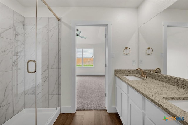 bathroom with a shower with door, vanity, and wood-type flooring