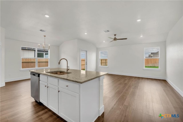 kitchen with stainless steel dishwasher, a kitchen island with sink, sink, and a wealth of natural light