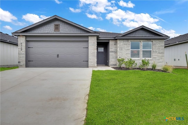 view of front facade with a front yard and a garage