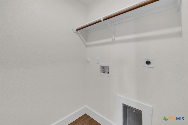 clothes washing area featuring hardwood / wood-style flooring, electric dryer hookup, hookup for a gas dryer, and hookup for a washing machine