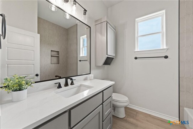 301 Canyon Oaks Rd, Troy, TX 76579 - full bathroom featuring a healthy amount of sunlight, vanity, baseboards, and toilet