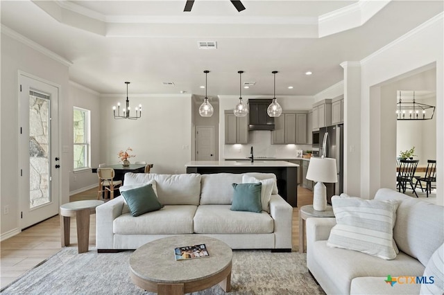 301 Canyon Oaks Rd, Troy, TX 76579 - living area featuring light wood-style floors, crown molding, a tray ceiling, and visible vents